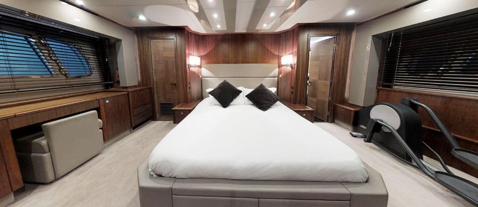 a room with a bed and a desk aboard NEMESIS Yacht for Sale