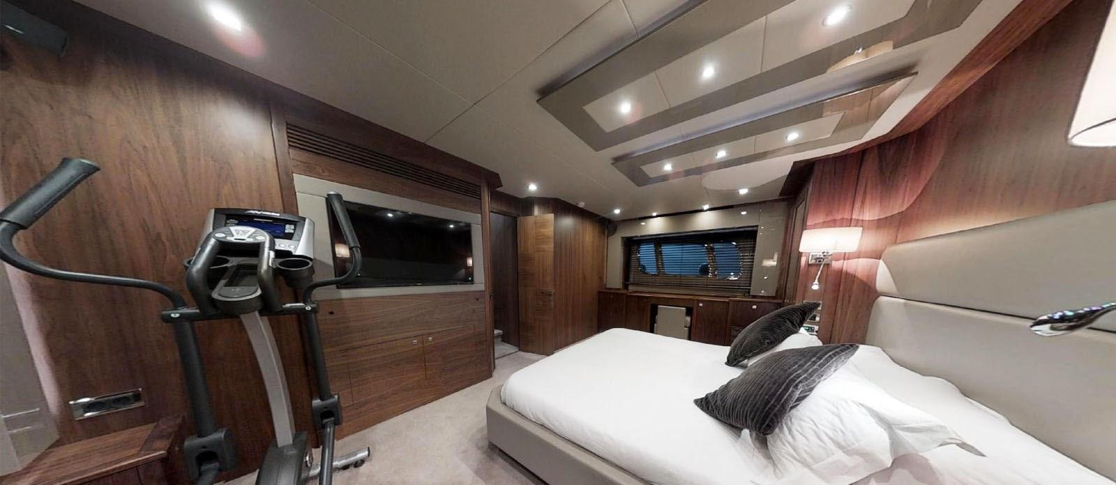 a room with a bed and a television aboard NEMESIS Yacht for Sale