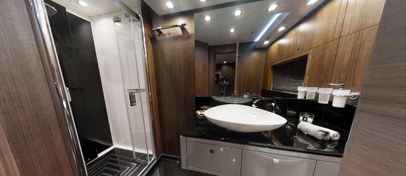 a bathroom with a sink and a shower aboard NEMESIS Yacht for Sale