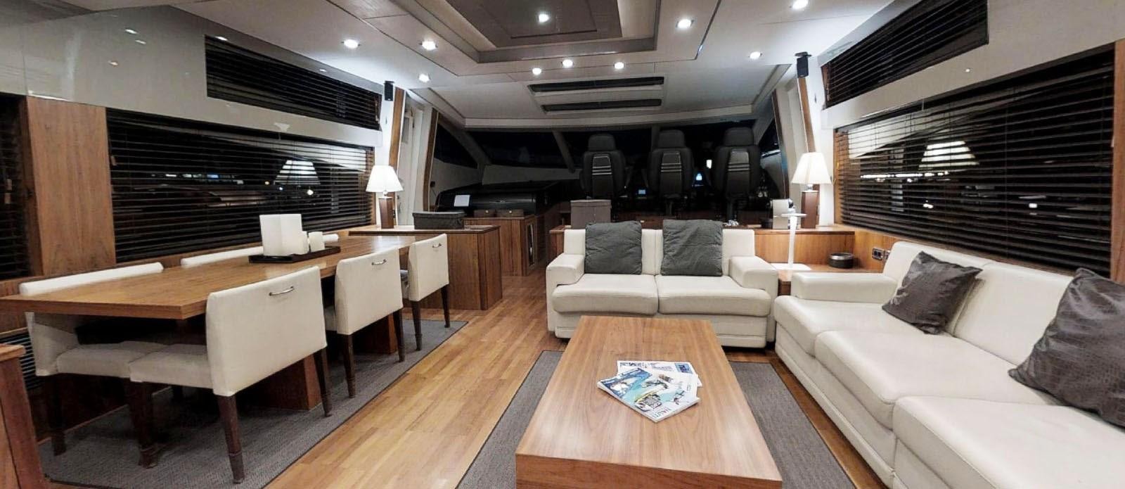 a living room with a couch and a table aboard NEMESIS Yacht for Sale