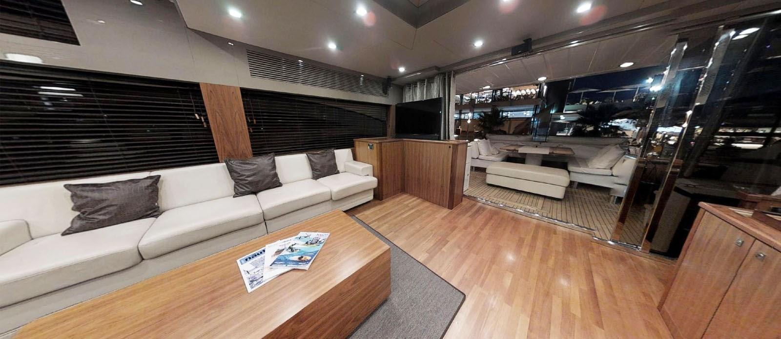 a room with a couch and a table aboard NEMESIS Yacht for Sale