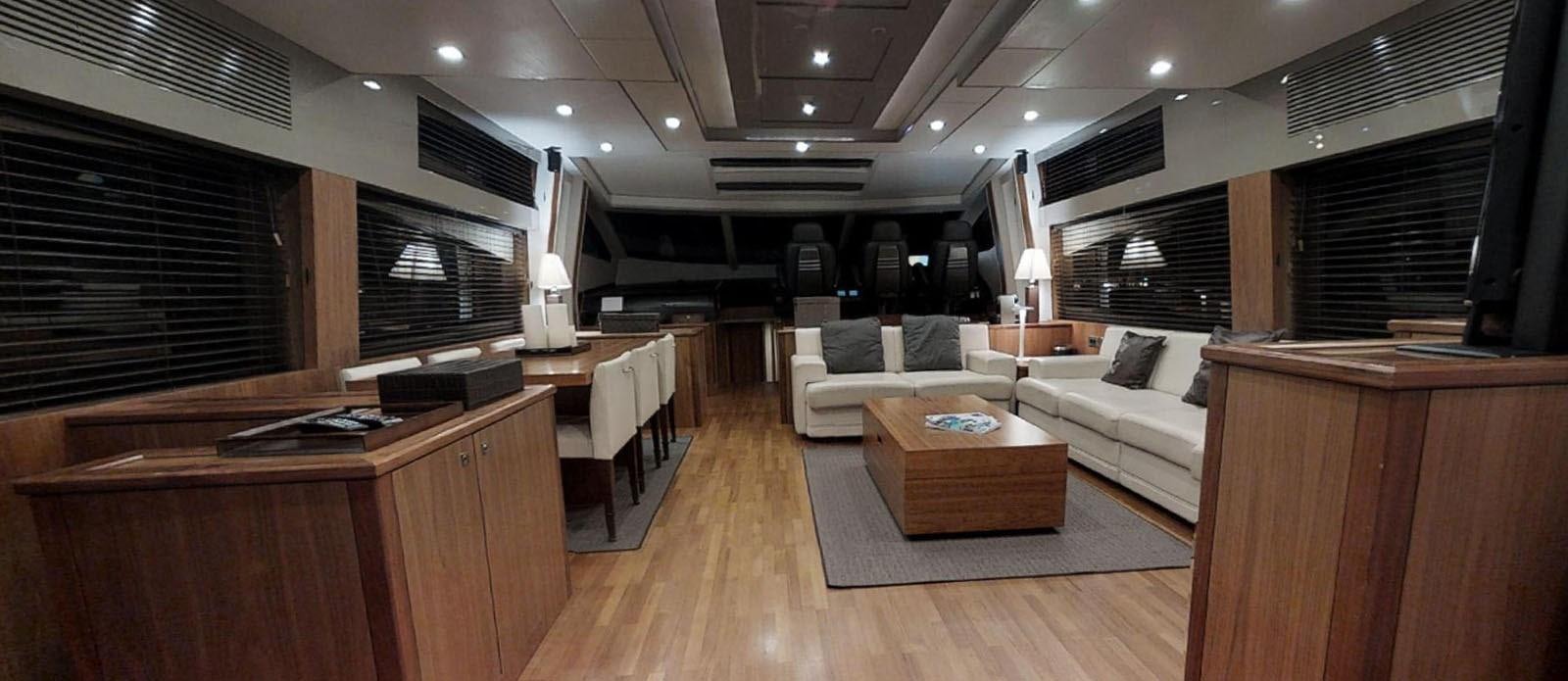 a living room with a couch and a coffee table aboard NEMESIS Yacht for Sale