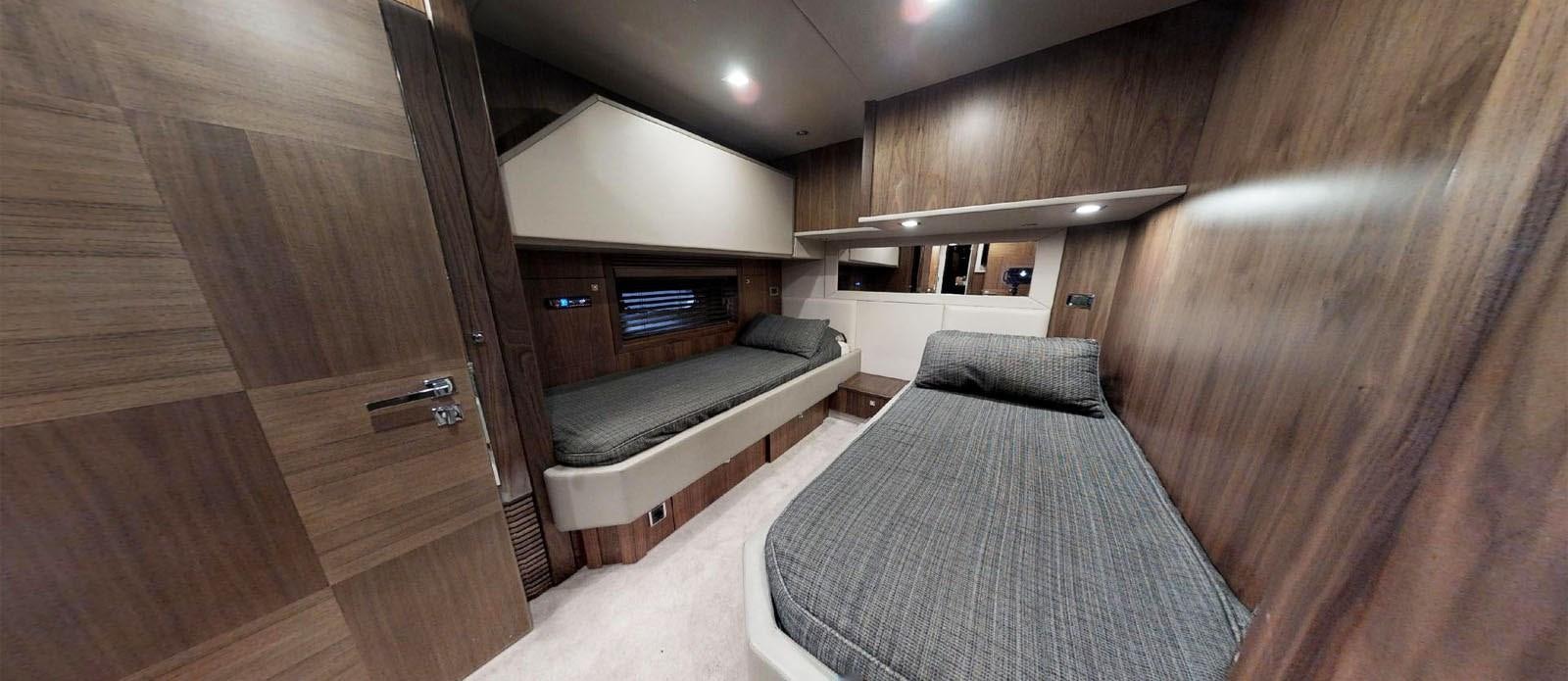 a room with a bed and a couch aboard NEMESIS Yacht for Sale
