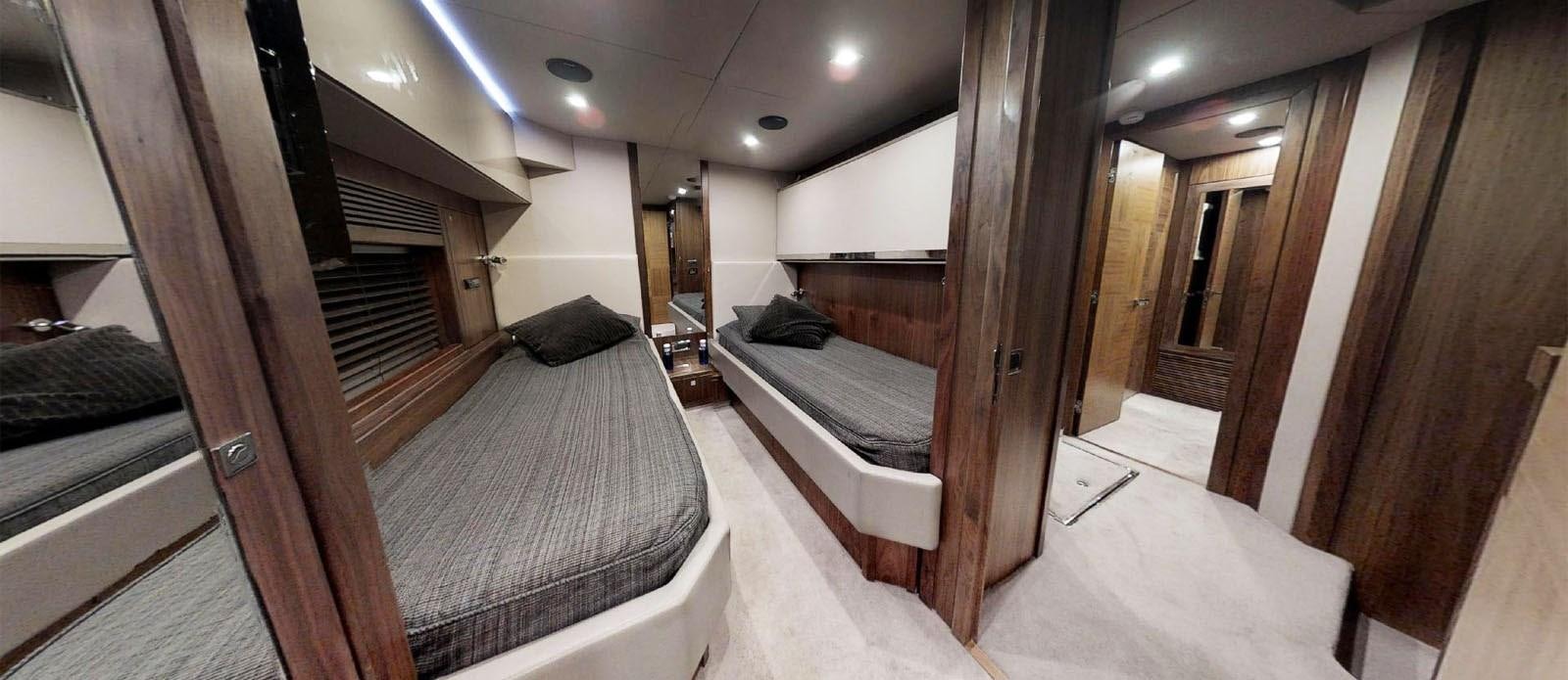 a room with a bed and a wood door aboard NEMESIS Yacht for Sale