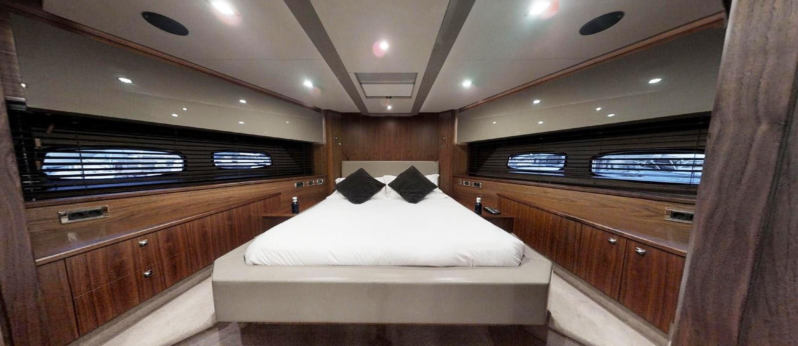a room with a bed and cabinets aboard NEMESIS Yacht for Sale