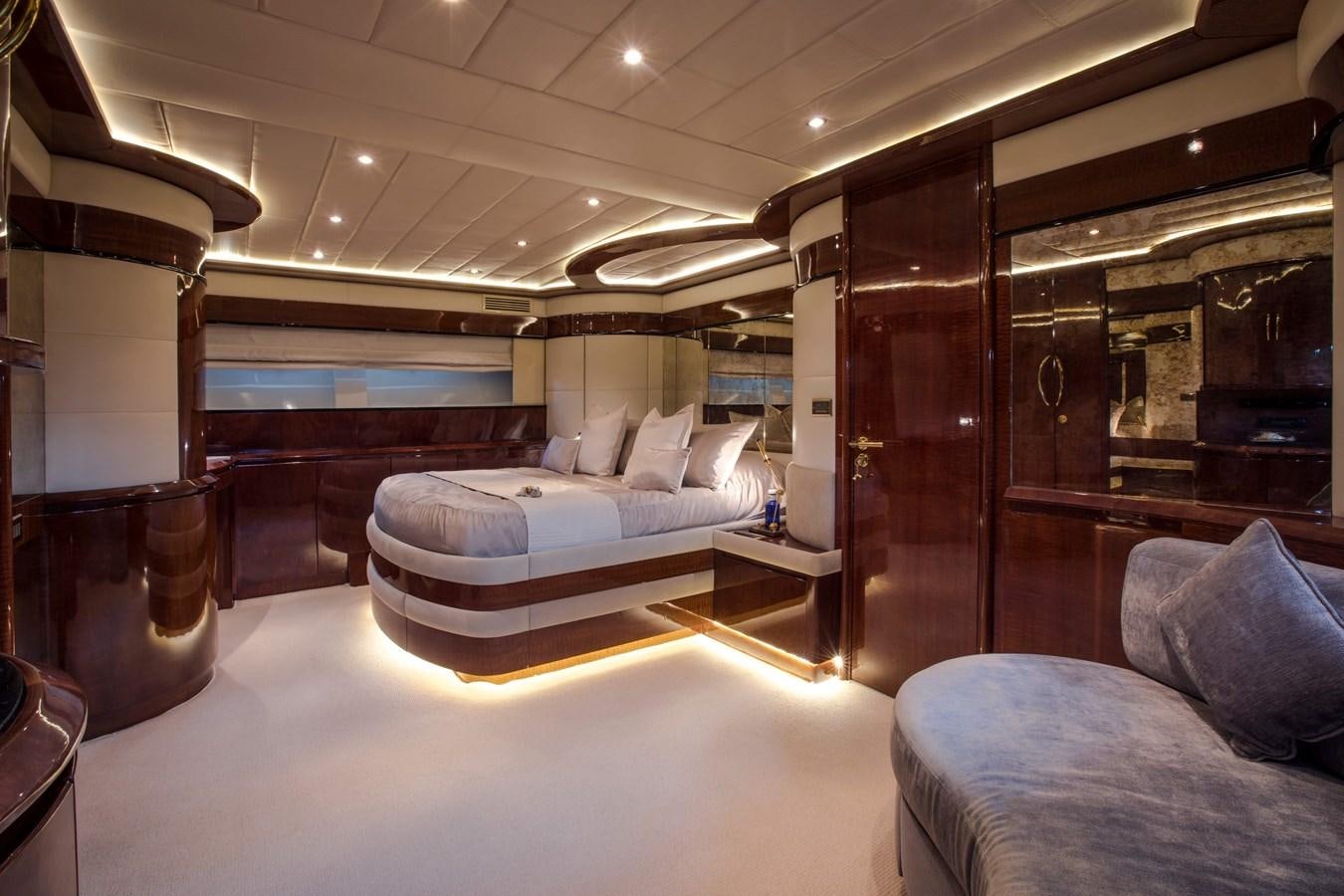 a living room with a couch and a large mirror aboard SERAPH Yacht for Sale