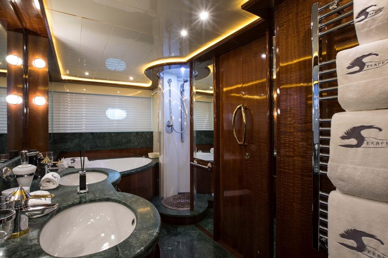 a bathroom with a sink and a large mirror aboard SERAPH Yacht for Sale