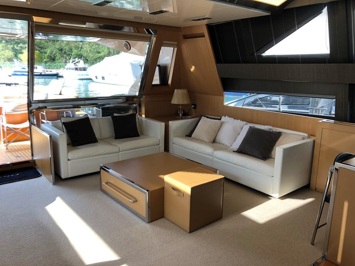 a living room with a couch and a coffee table aboard RIVA 86 Yacht for Sale