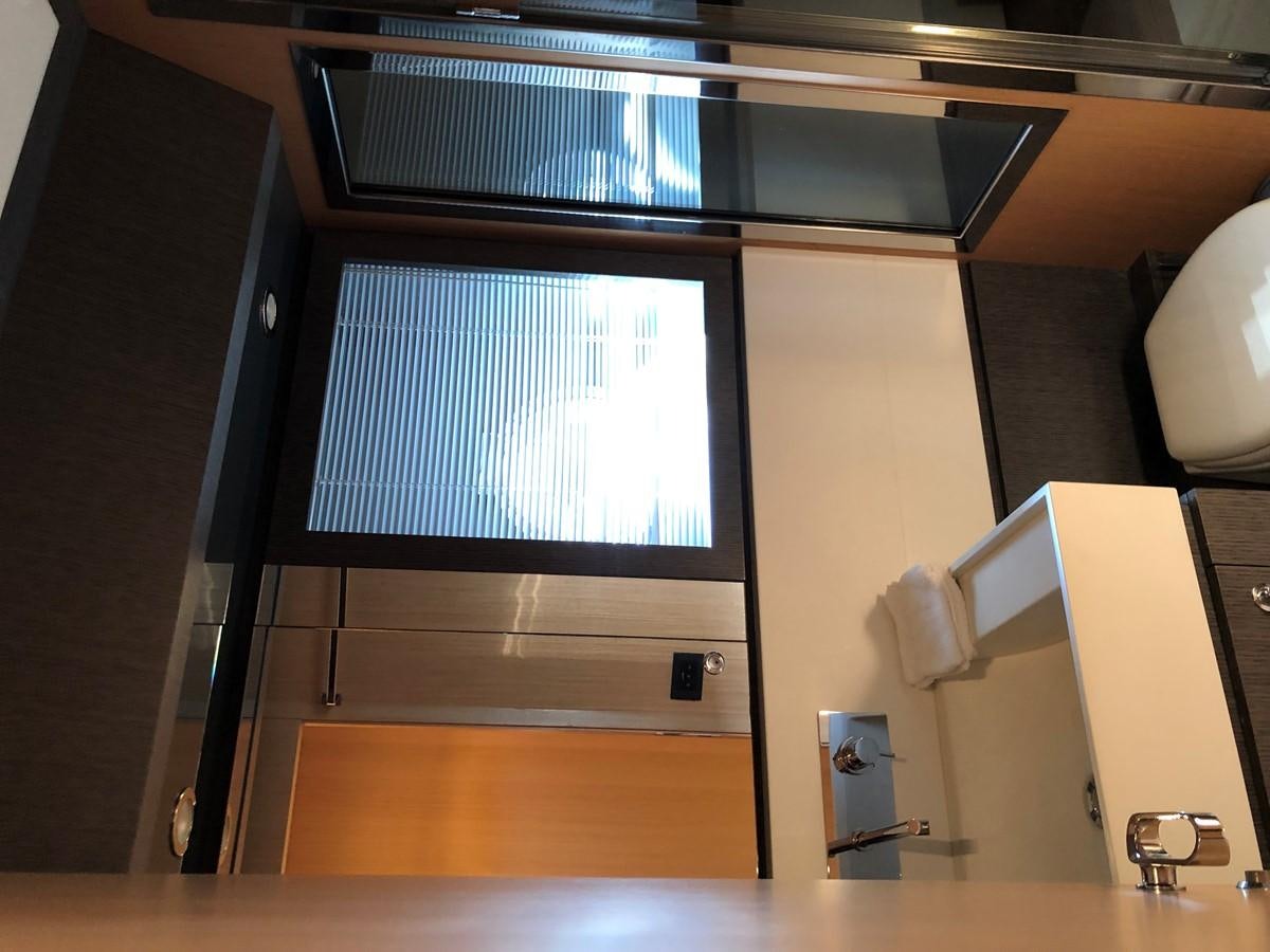 a room with a window and a desk aboard RIVA 86 Yacht for Sale