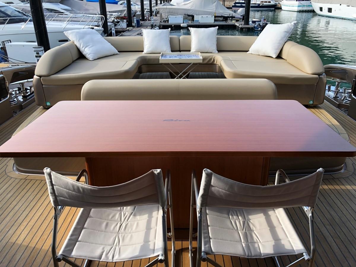 a table with chairs around it aboard RIVA 86 Yacht for Sale