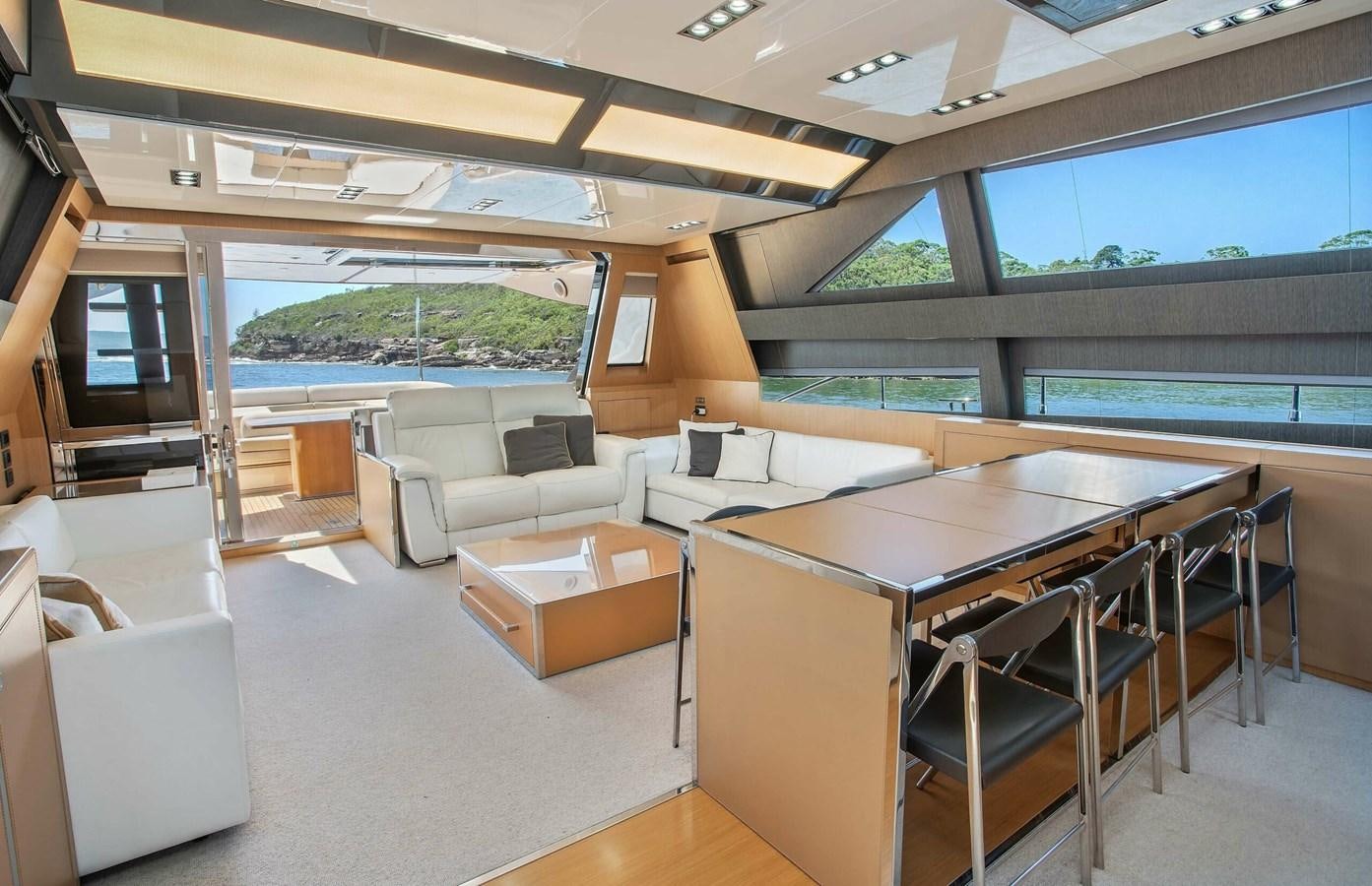 a large room with a table and chairs aboard RIVA 88 DOMINO Yacht for Sale