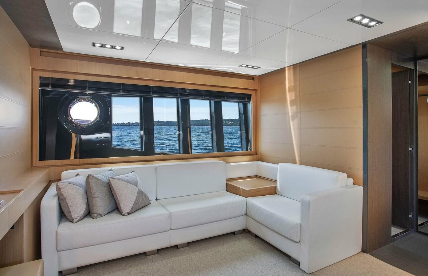 a white couch in a room aboard RIVA 88 DOMINO Yacht for Sale