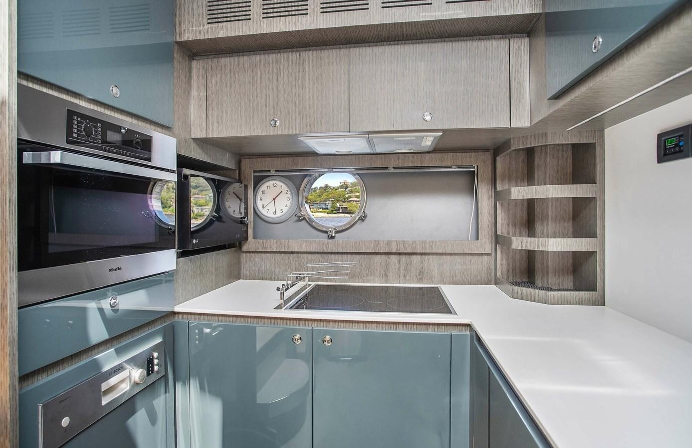 a kitchen with a microwave oven and a sink aboard RIVA 88 DOMINO Yacht for Sale