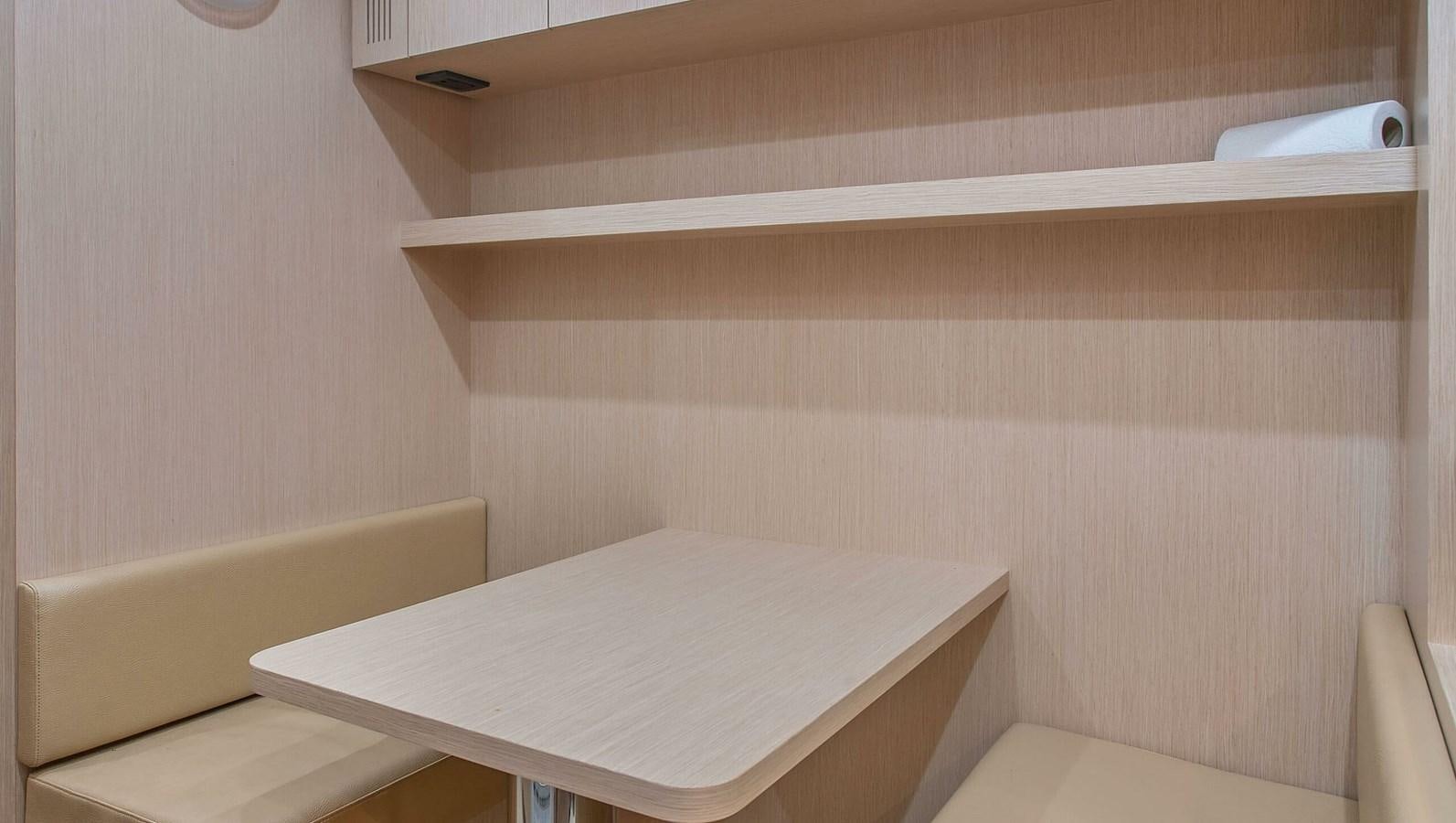 a white table with a white table aboard RIVA 88 DOMINO Yacht for Sale