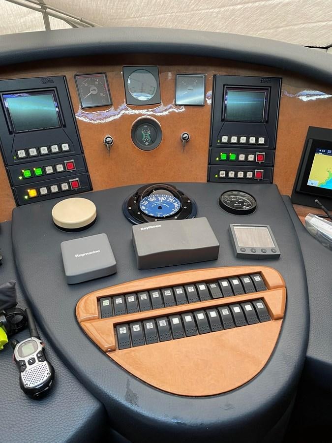 a wooden panel with a keyboard and a variety of devices on it aboard AZIMUT 85 ULTIMATE Yacht for Sale