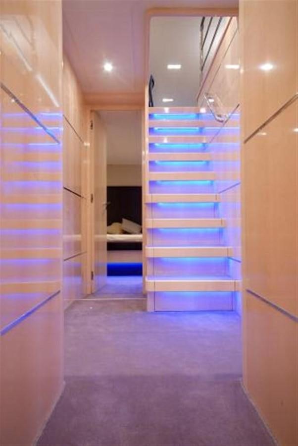 a hallway with a blue staircase aboard SANS SOUCI Yacht for Sale