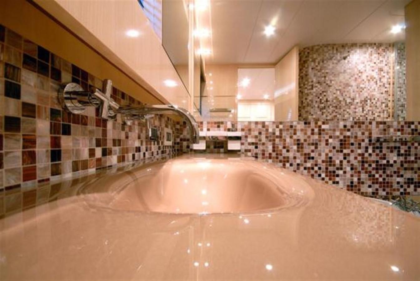 a large bathtub with a shower curtain aboard SANS SOUCI Yacht for Sale