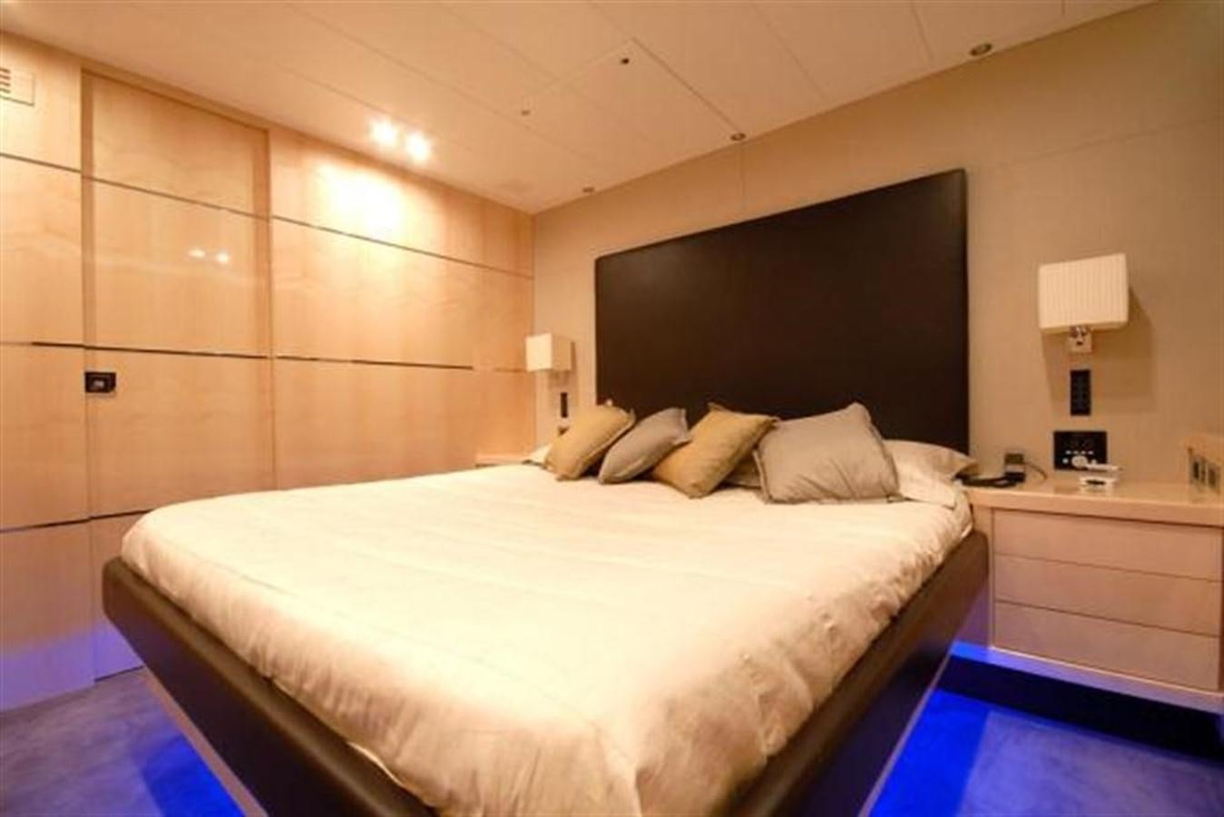 a bedroom with a bed and a desk aboard SANS SOUCI Yacht for Sale