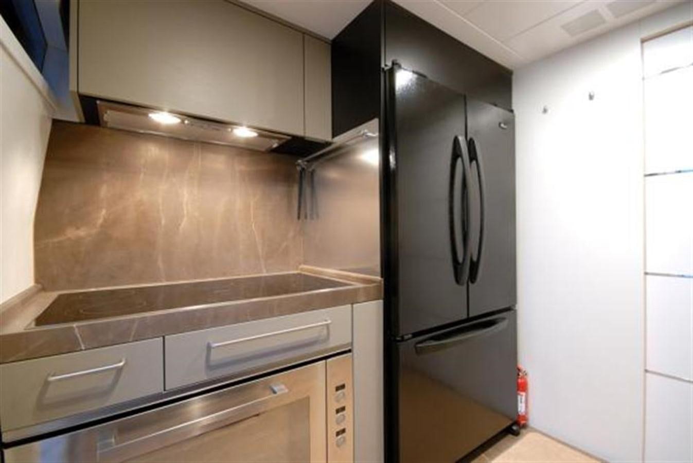 a kitchen with a refrigerator aboard SANS SOUCI Yacht for Sale