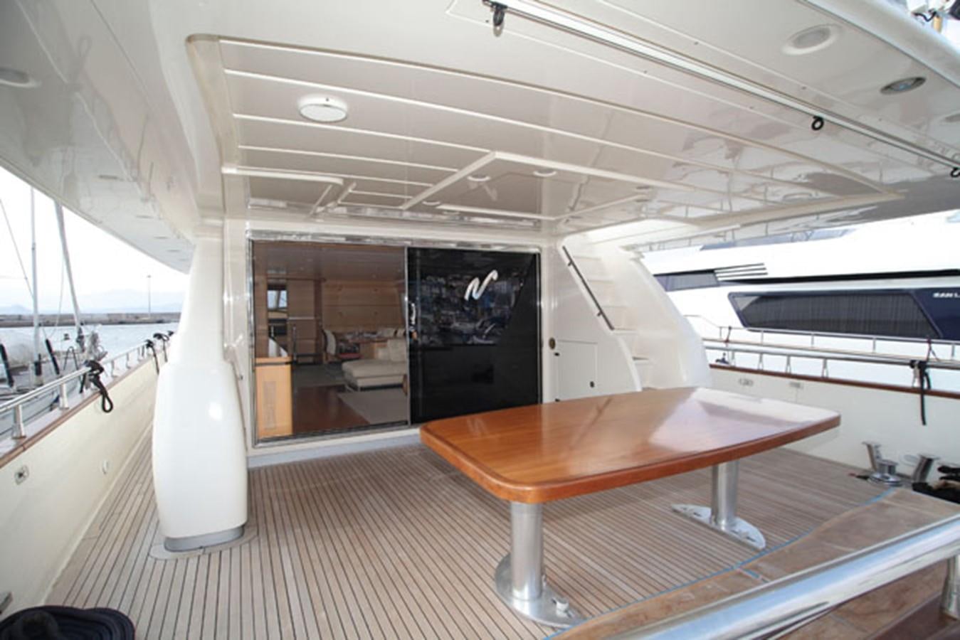 a room with a table and a bench aboard CANADOS 86 Yacht for Sale