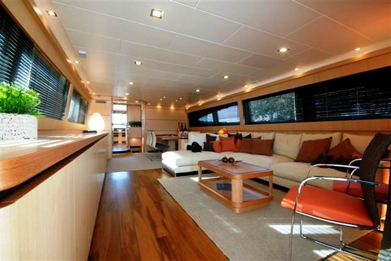 a living room with a couch and a table aboard CANADOS 86 Yacht for Sale