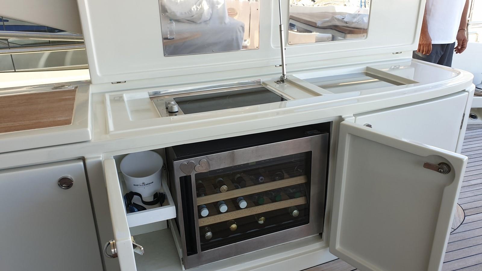 a kitchen with a stove and a microwave aboard MR LEO Yacht for Sale