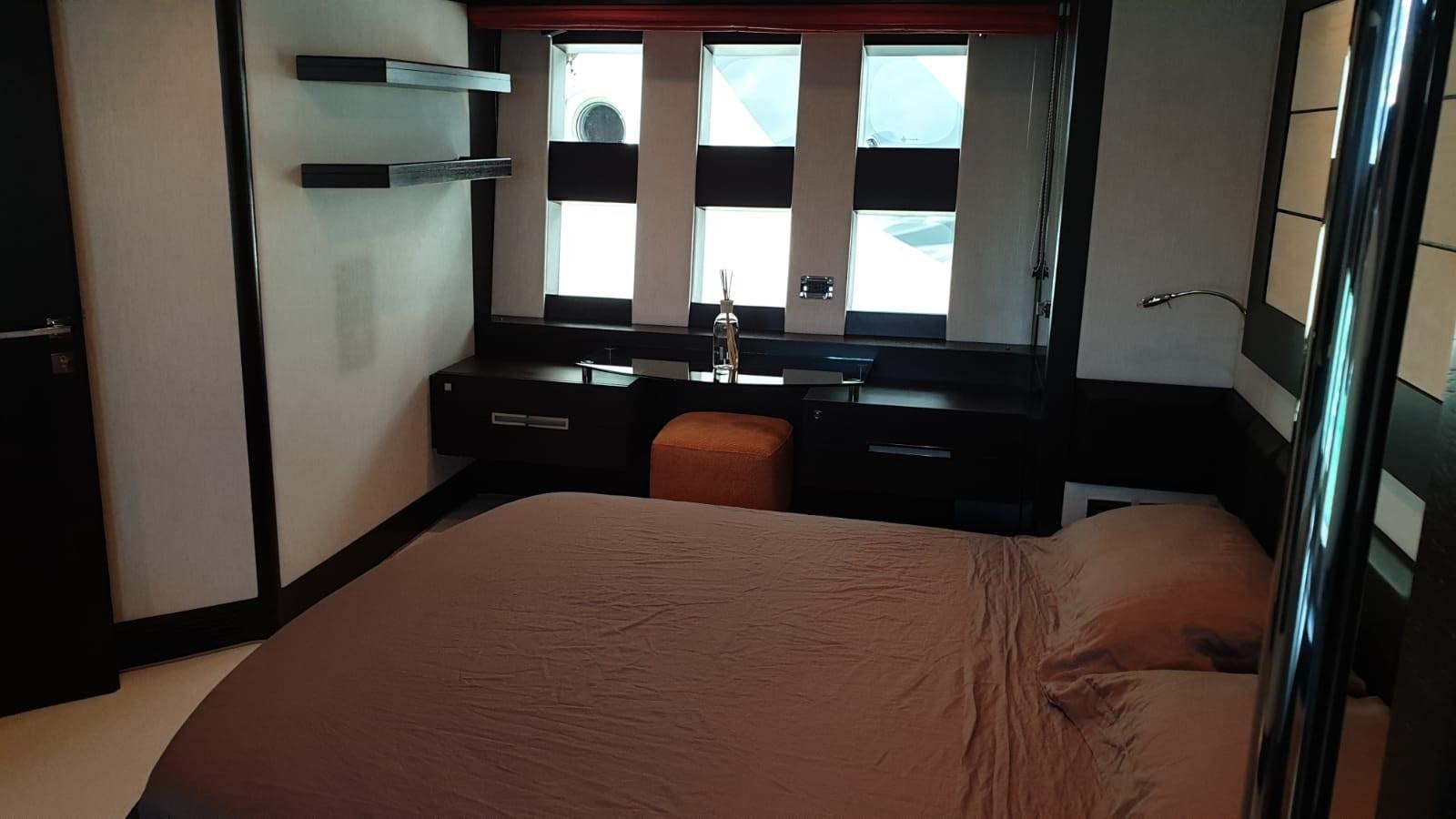 a person lying on a bed aboard MR LEO Yacht for Sale