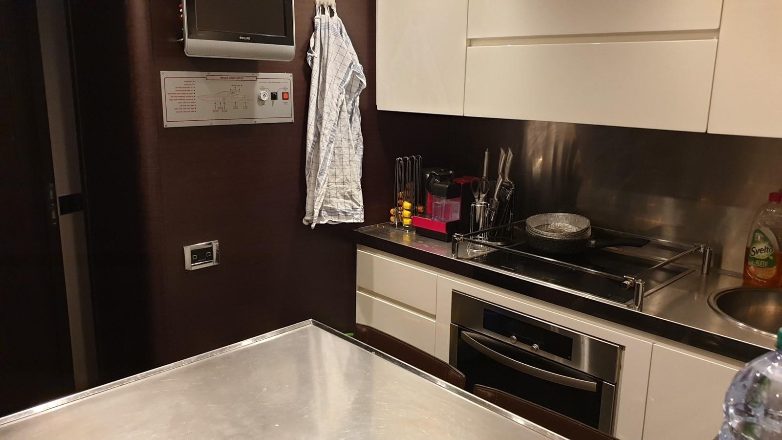 a kitchen with a stove and microwave aboard MR LEO Yacht for Sale