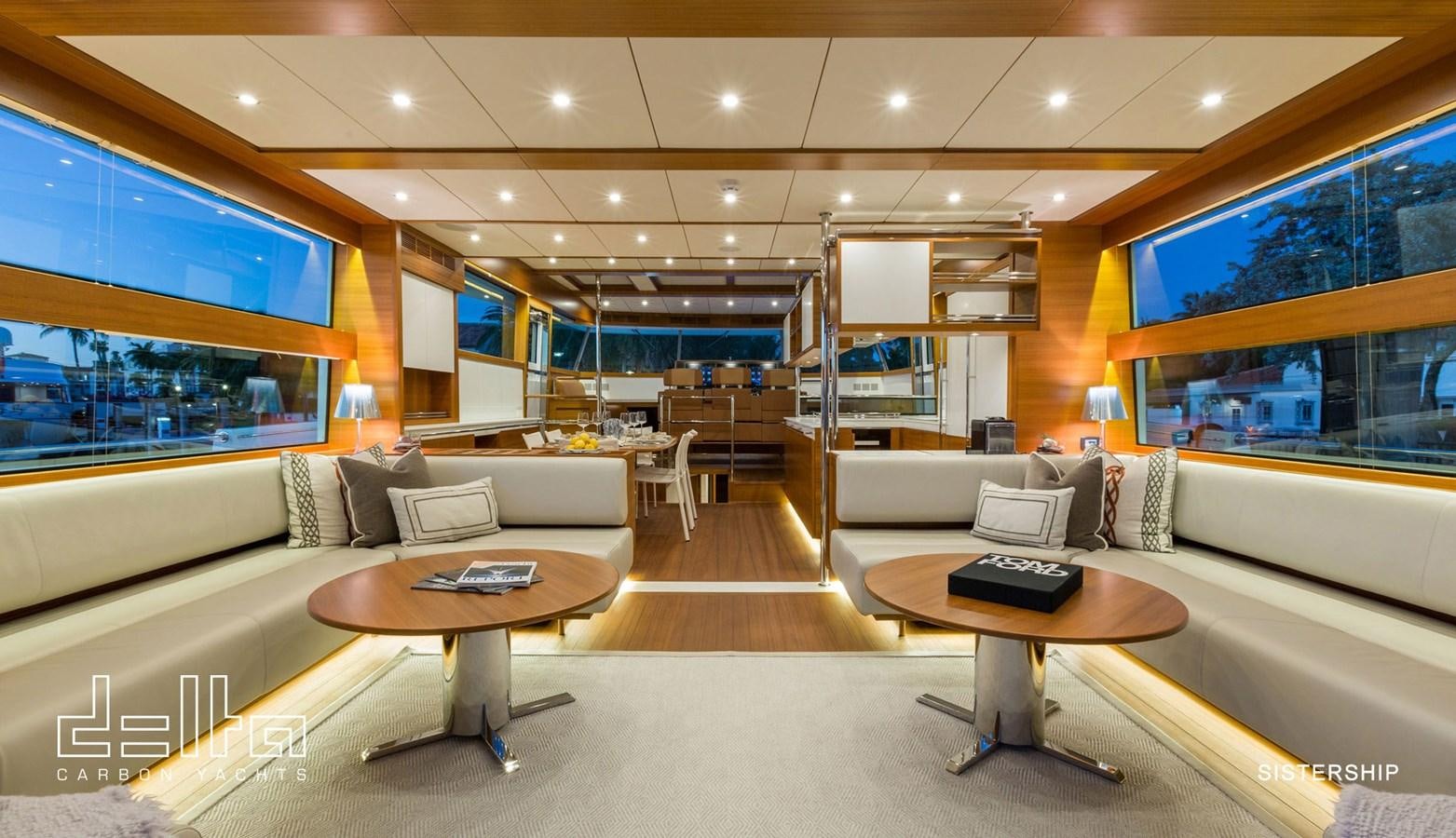 a living room with a couch and a table aboard DELTA 88 CARBON Yacht for Sale