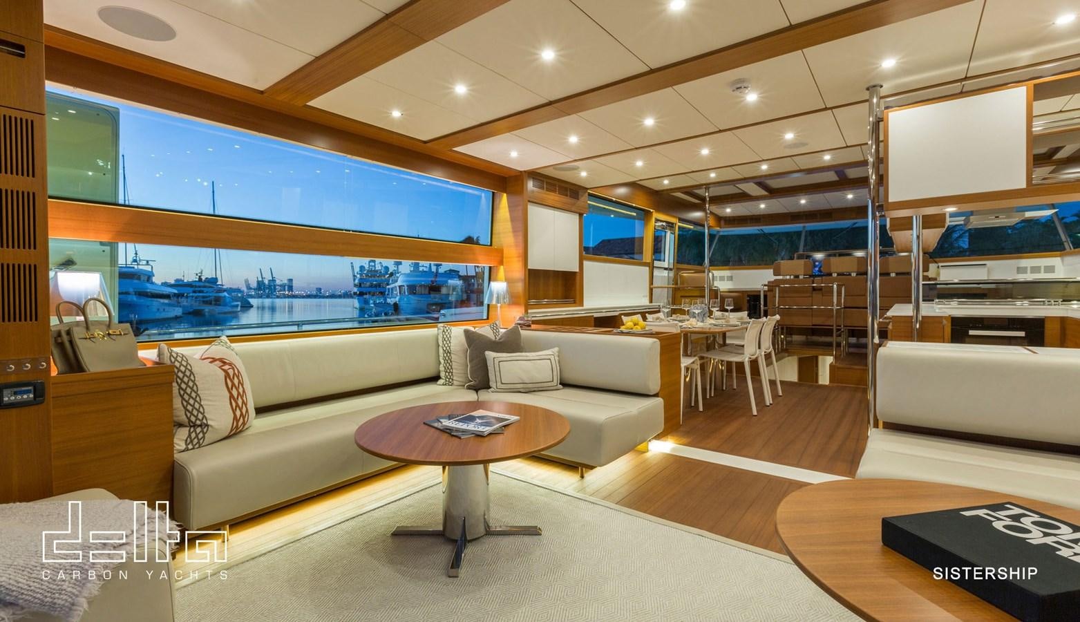 a living room with a couch and a table aboard DELTA 88 CARBON Yacht for Sale