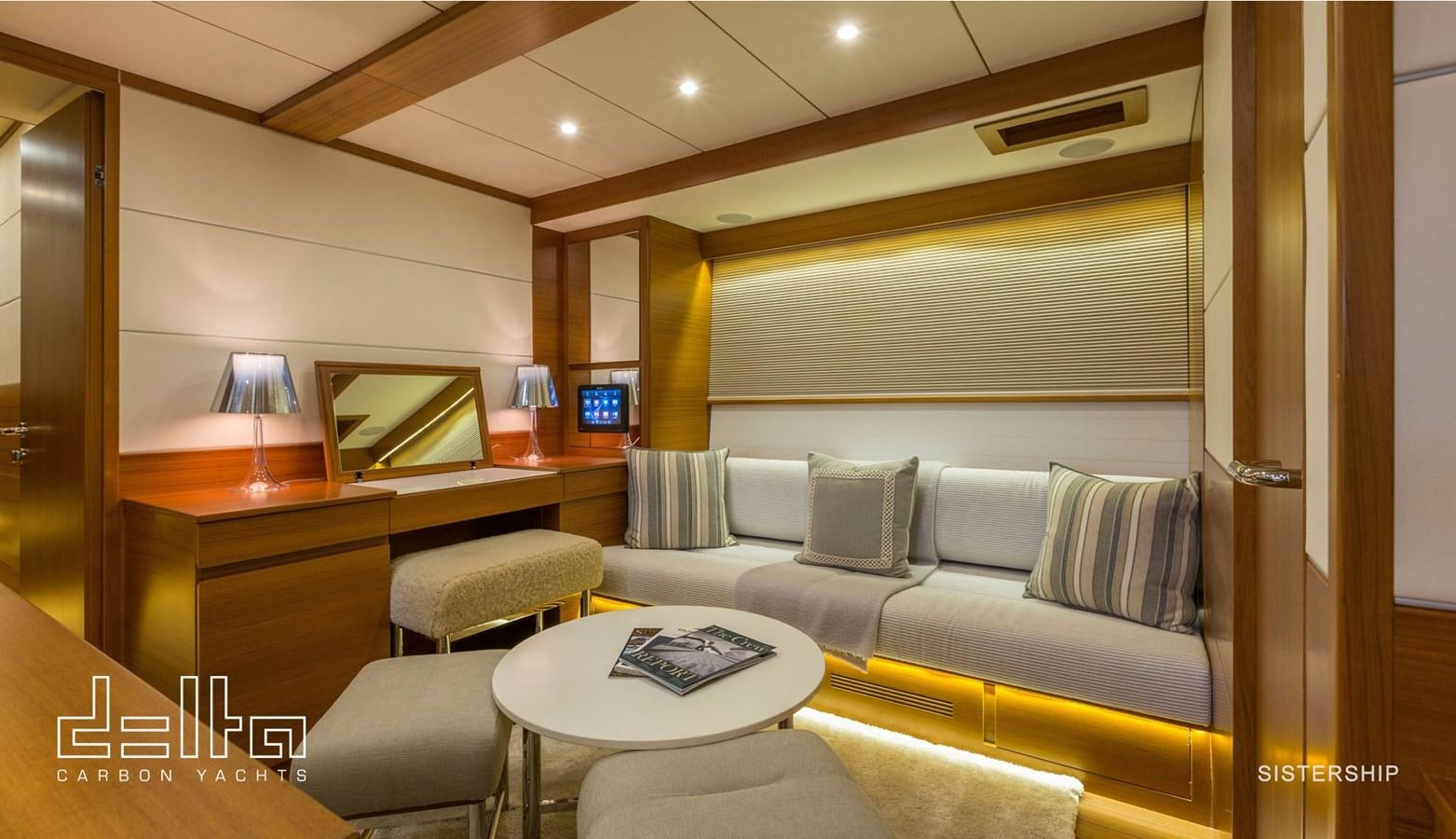 a living room with a couch and a table aboard DELTA 88 CARBON Yacht for Sale