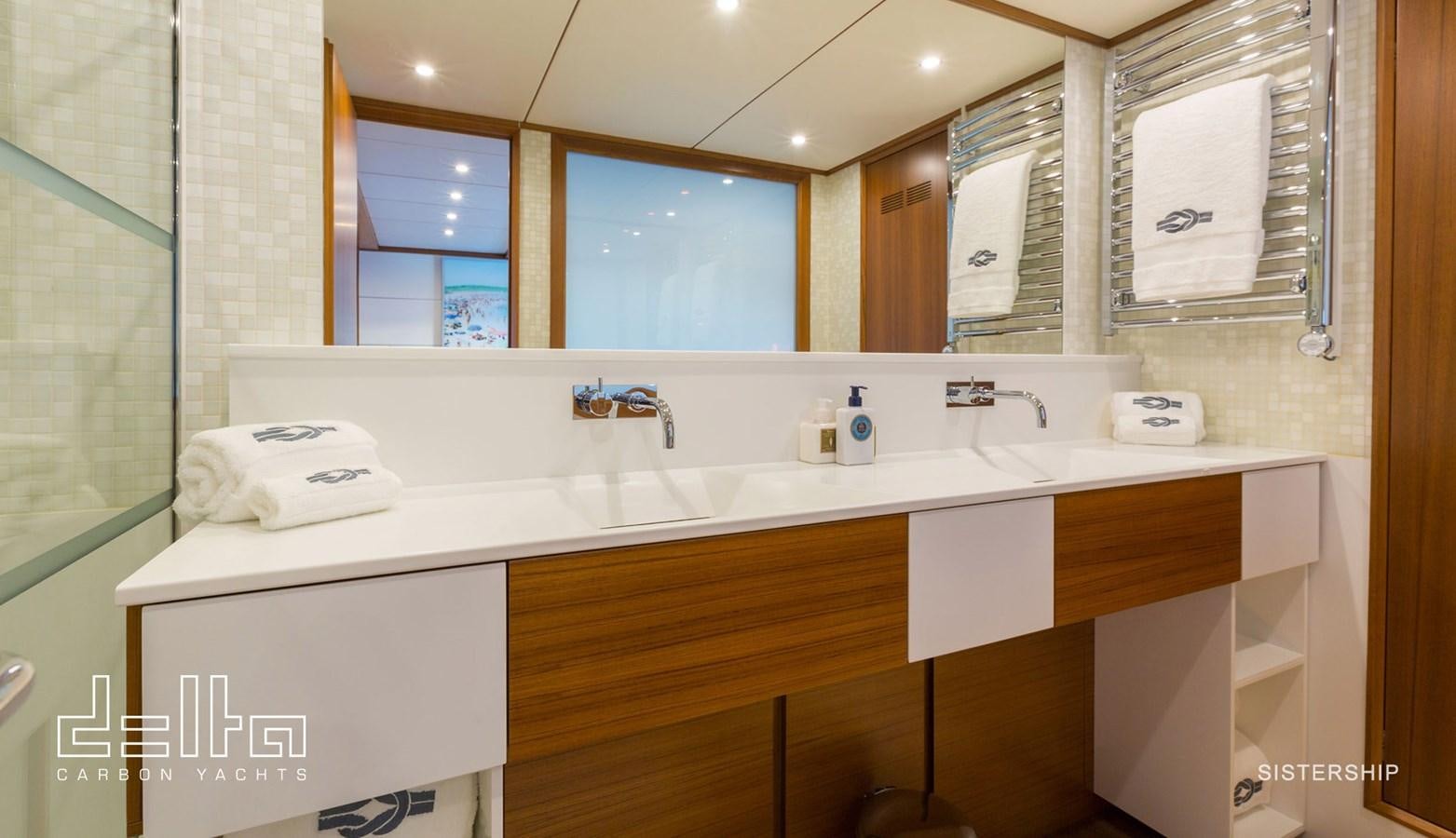 a bathroom with a large mirror aboard DELTA 88 CARBON Yacht for Sale