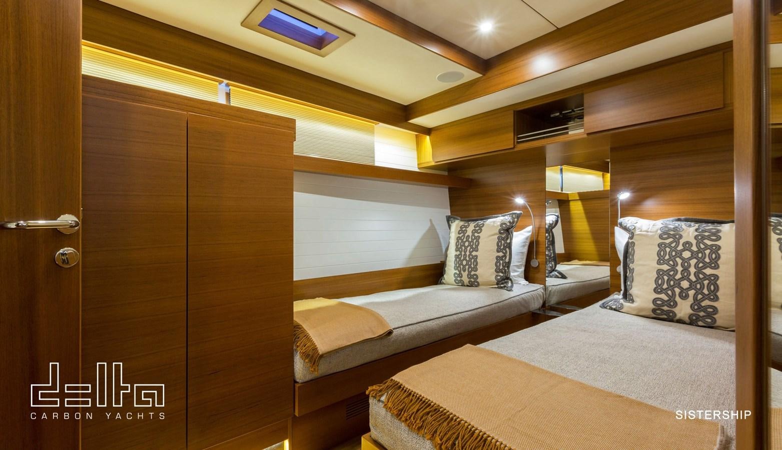 a room with a bed and a door aboard DELTA 88 CARBON Yacht for Sale