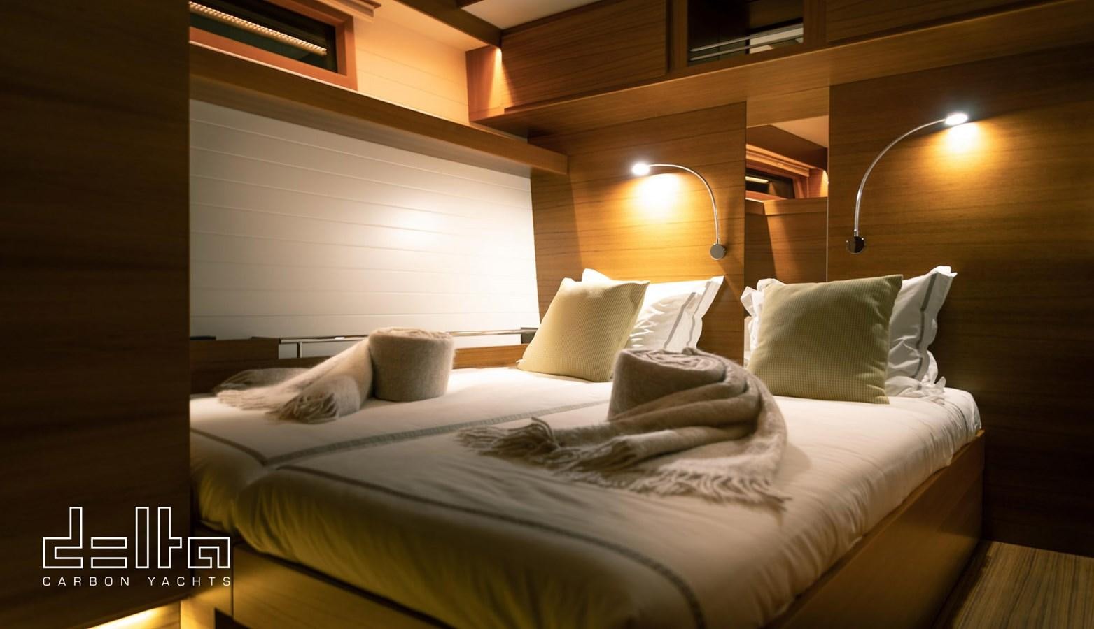 a bed with pillows aboard DELTA 88 CARBON Yacht for Sale