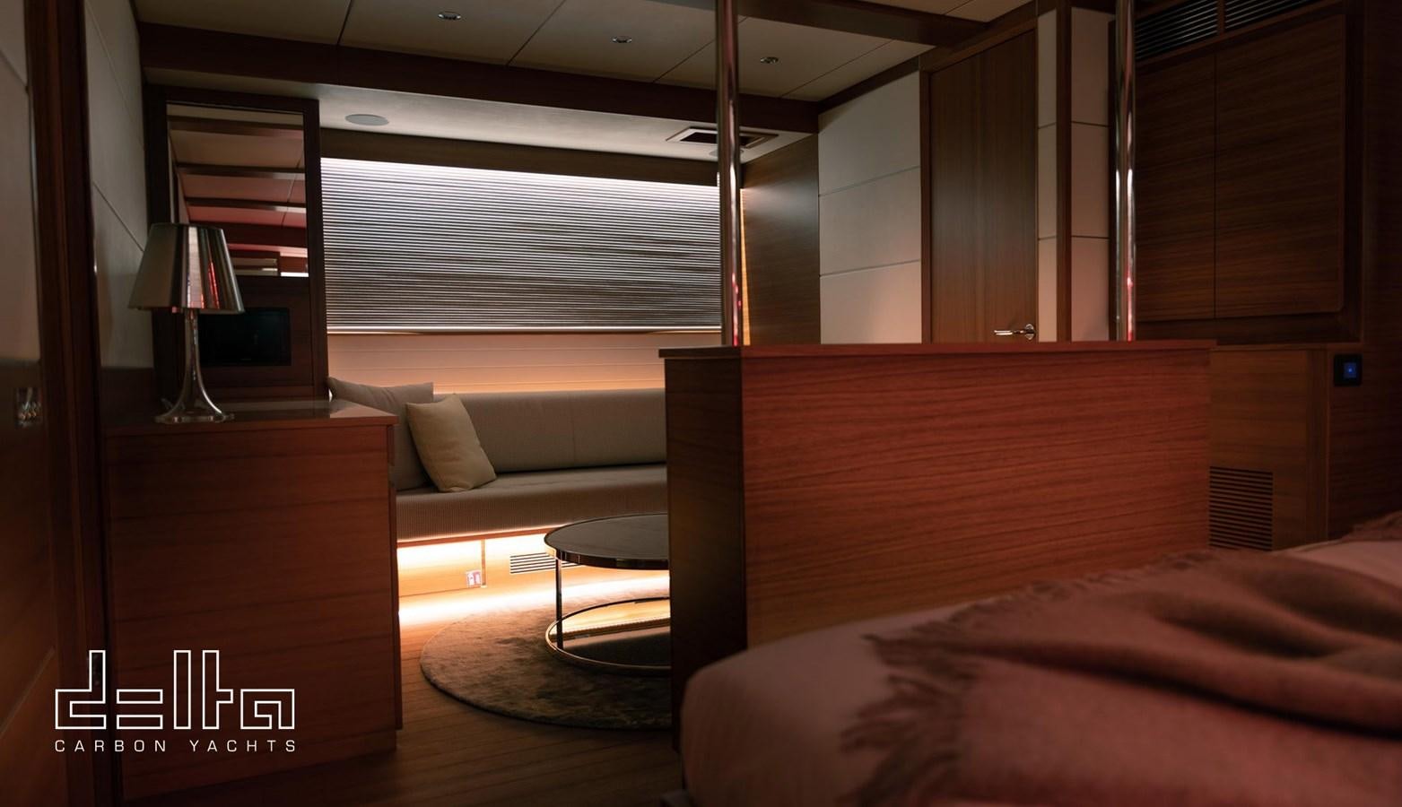 a room with a bed and a desk aboard DELTA 88 CARBON Yacht for Sale