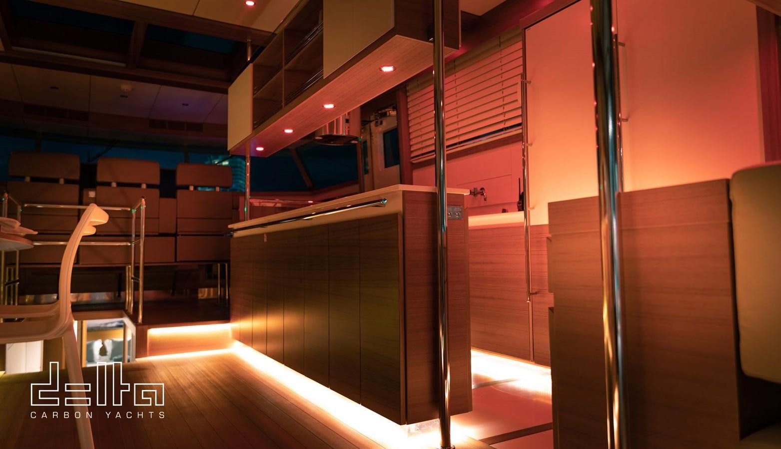 a room with a large shelf with computer screens aboard DELTA 88 CARBON Yacht for Sale