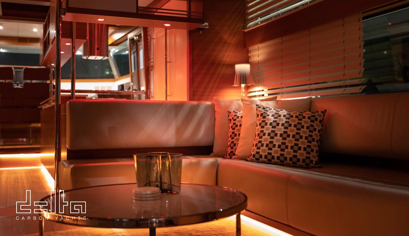 a living room with a couch and coffee table aboard DELTA 88 CARBON Yacht for Sale