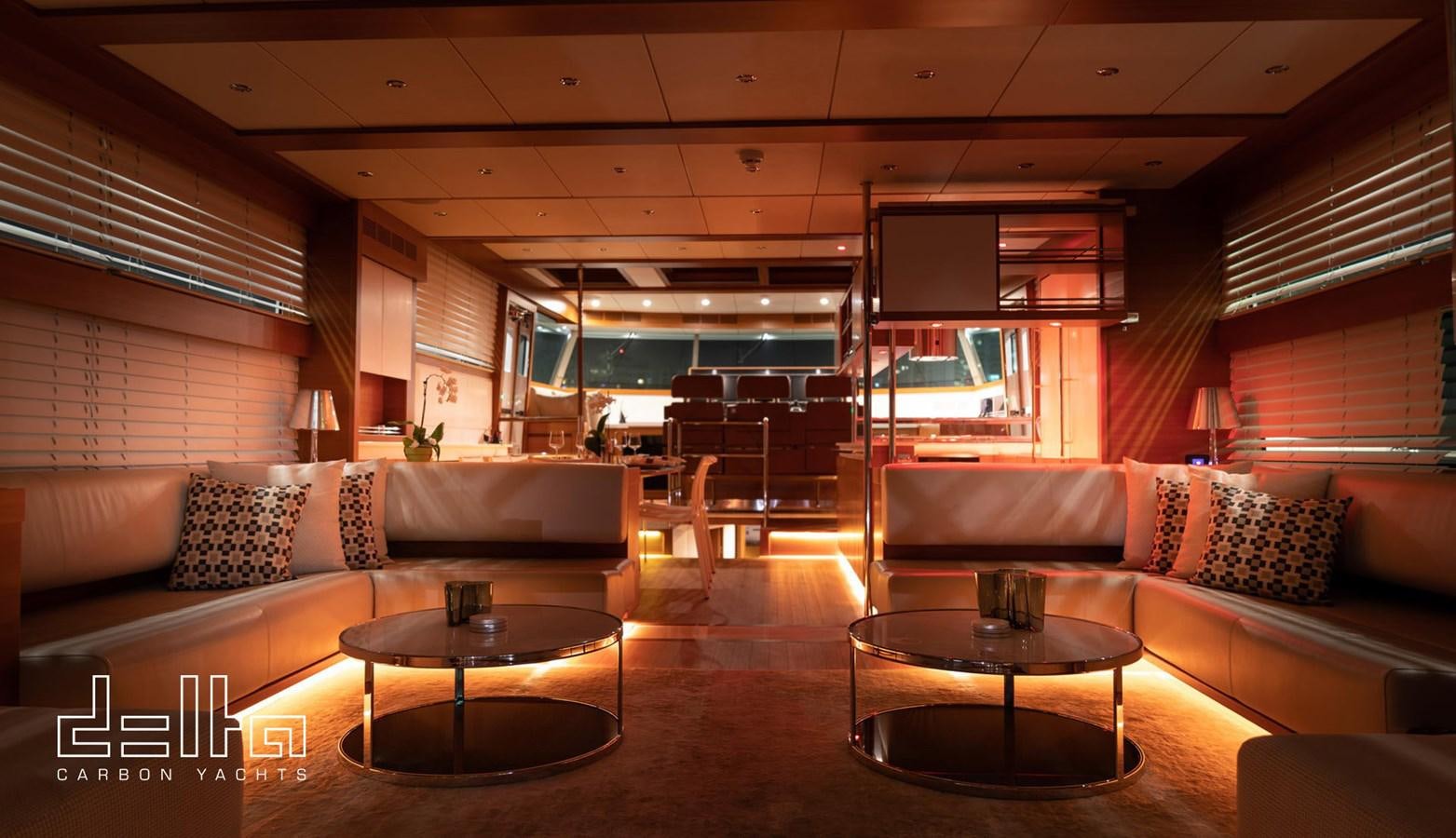 a living room with a couch and a table aboard DELTA 88 CARBON Yacht for Sale