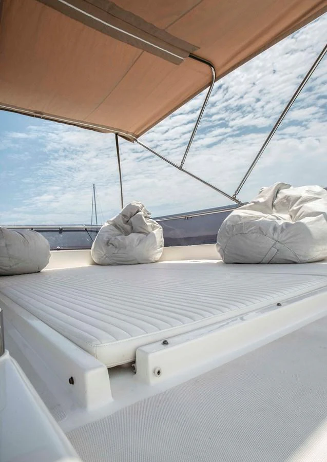a white bed under a roof aboard NUR Yacht for Sale