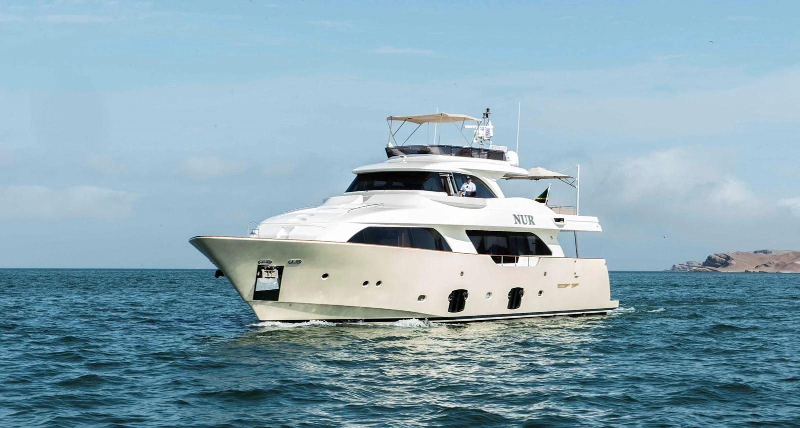 a white yacht in the water aboard NUR Yacht for Sale