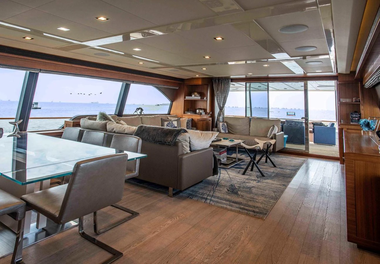 a living room with a couch and a table aboard NUR Yacht for Sale