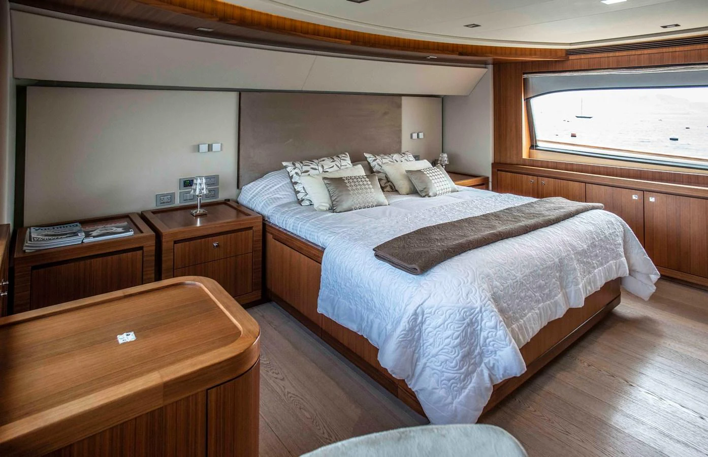 a bedroom with a bed and a desk aboard NUR Yacht for Sale