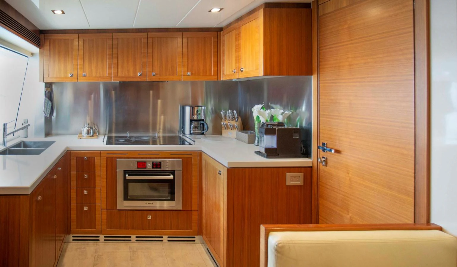 a kitchen with wooden cabinets aboard NUR Yacht for Sale