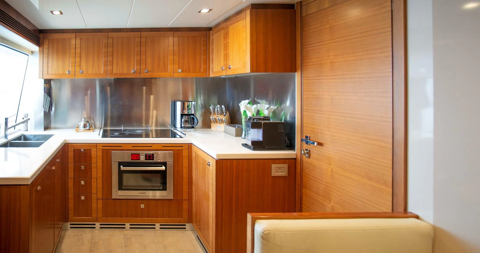 a kitchen with wooden cabinets aboard NUR Yacht for Sale