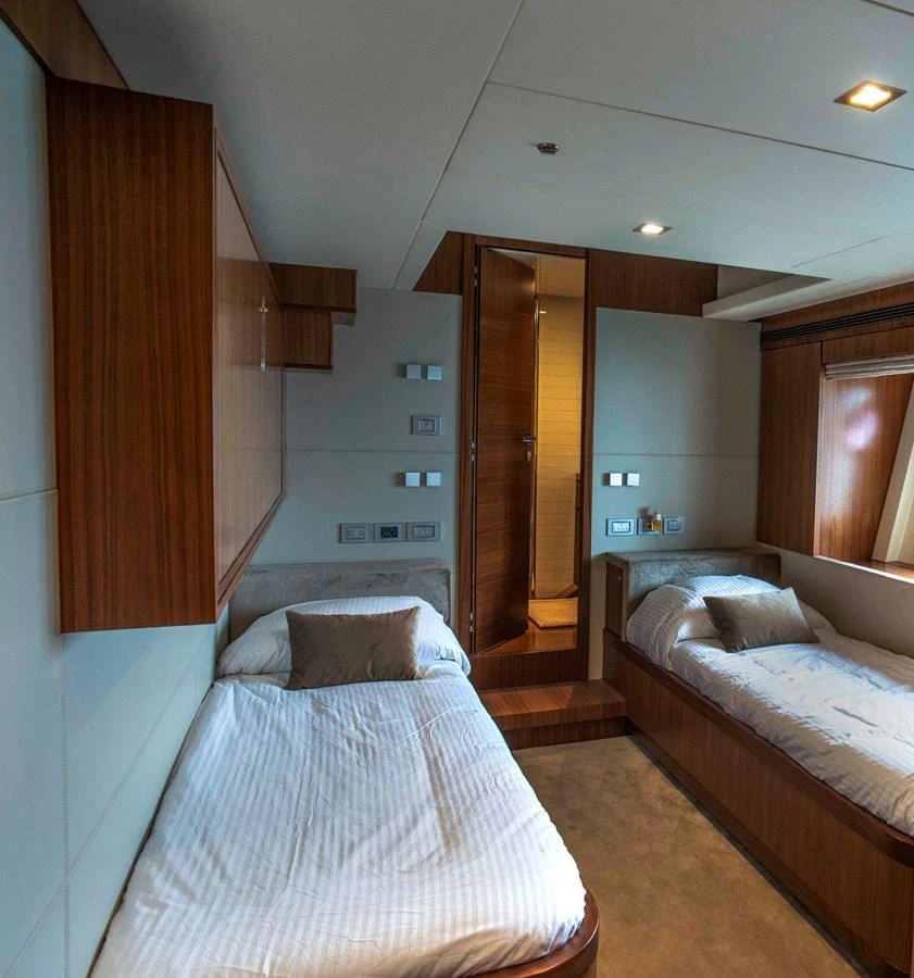 a bedroom with two beds aboard NUR Yacht for Sale