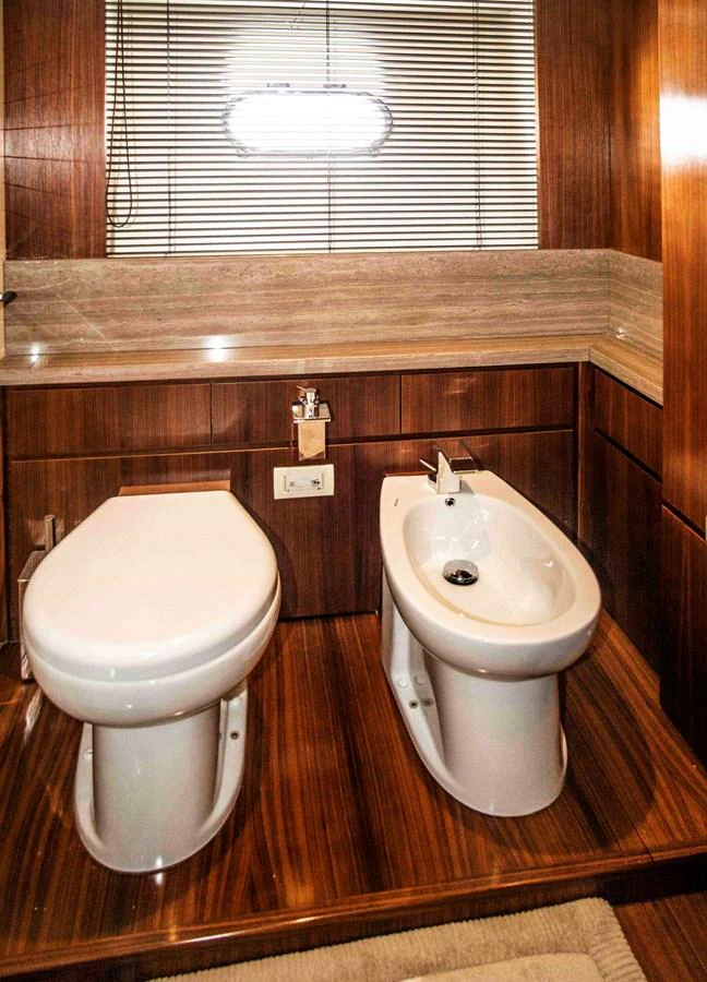 a bathroom with a toilet and a bidet aboard NUR Yacht for Sale