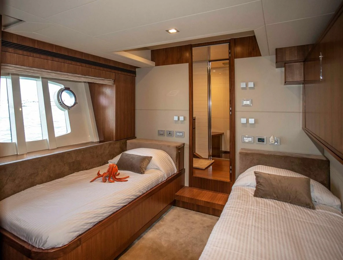 a bedroom with two beds aboard NUR Yacht for Sale