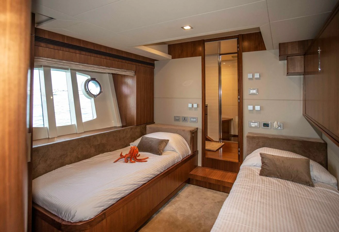 a bedroom with two beds aboard NUR Yacht for Sale