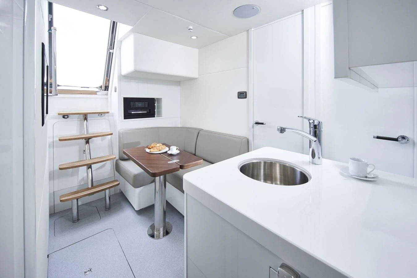 a kitchen with a table and a sink aboard PRINCESS 85MY 2019 Yacht for Sale