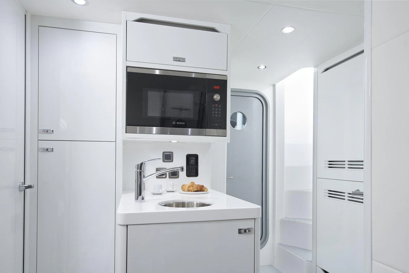 a kitchen with white cabinets aboard PRINCESS 85MY 2019 Yacht for Sale